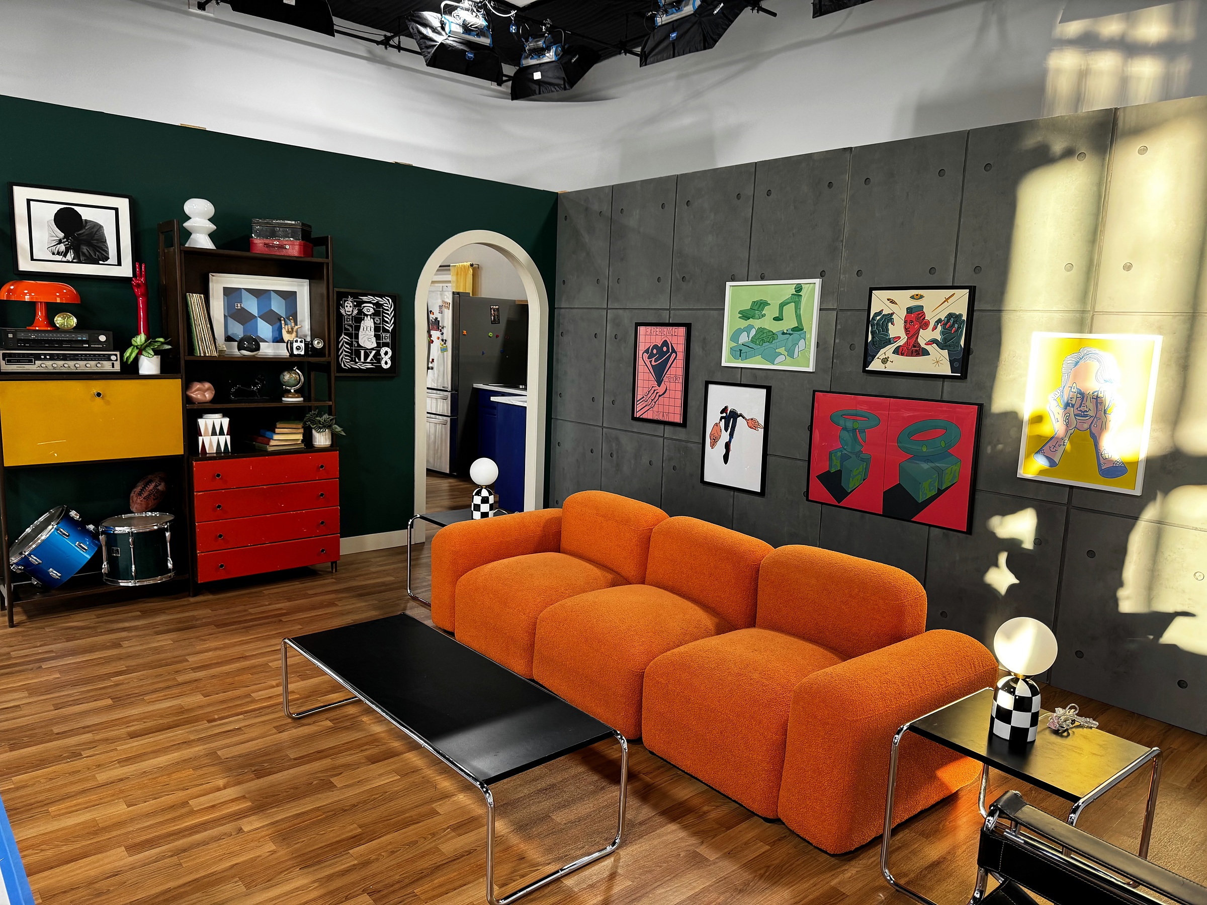 Constructed studio living environment with orange seating